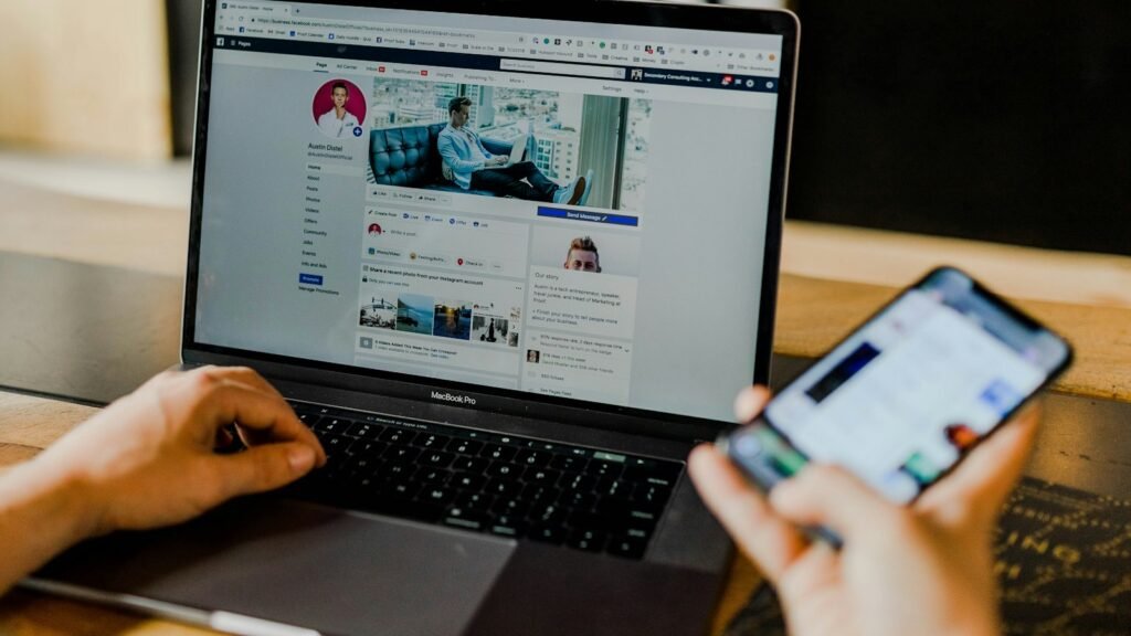 Άνθρωπος δουλεύει ταυτόχρονα σε laptop και κινητό
